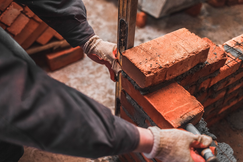 bricklayer-puts-bricks-to-make-a-wall-2023-11-27-05-05-19-utc.jpg