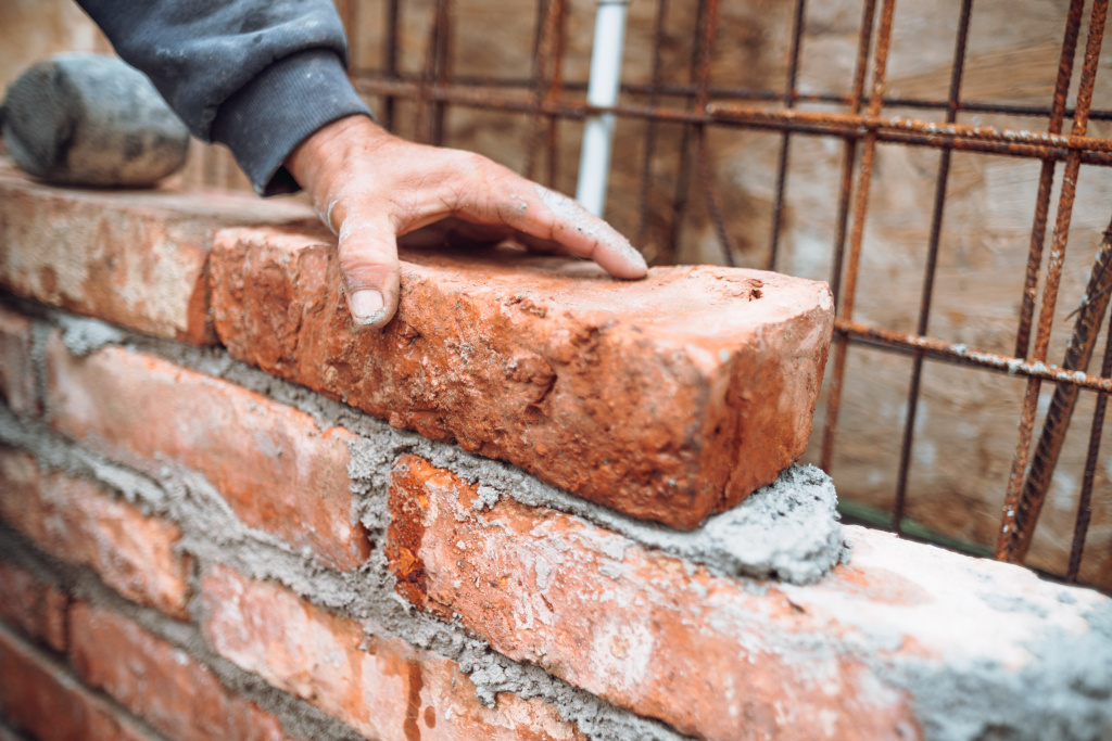 worker-laying-bricks-and-building-walls-on-constr-2023-11-27-05-30-35-utc.jpg