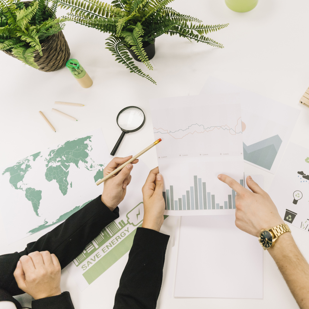 elevated-view-businesspeople-analyzing-graph-desk.jpg