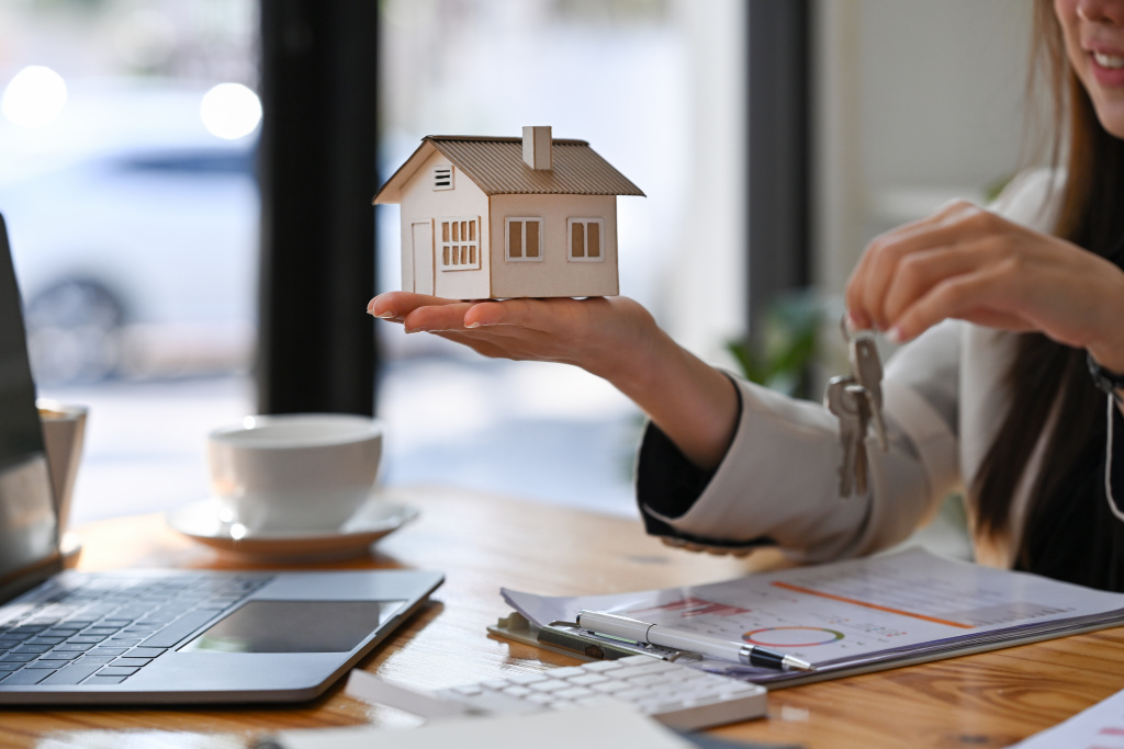 estate-agent-holding-house-model-and-house-key-in-2023-11-27-04-53-54-utc.JPG